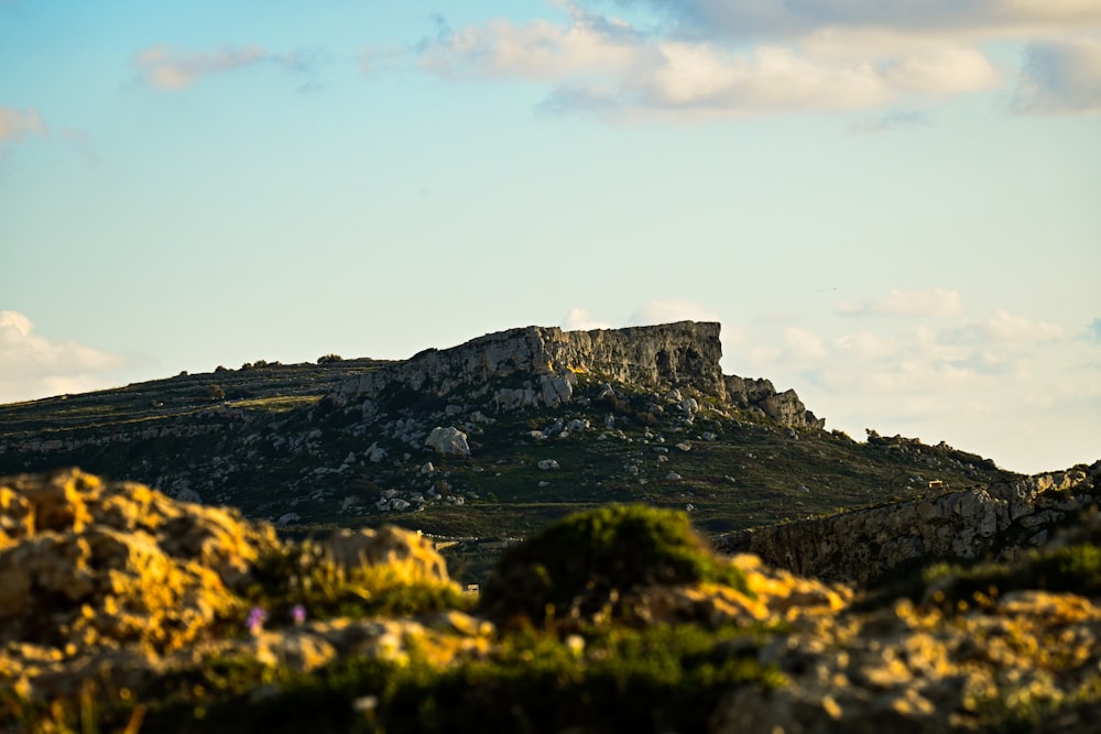 a mountain with a large rock outcropping on top of it