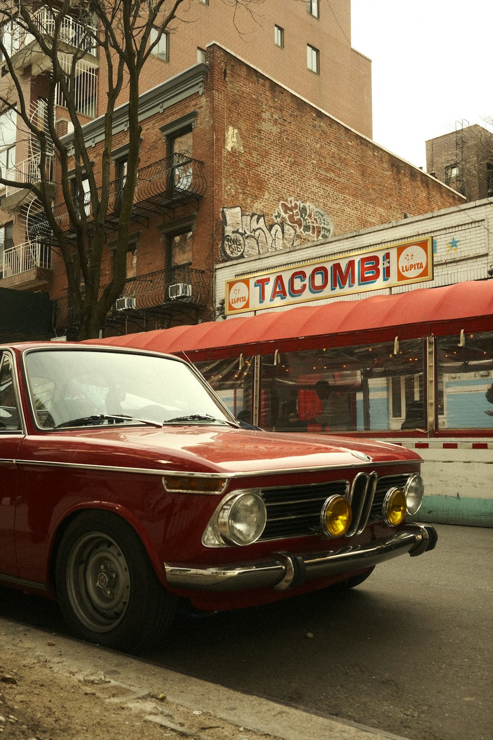 a red car parked on the side of the road