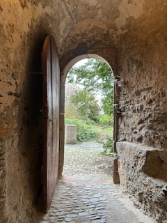 an open door leading to a stone path