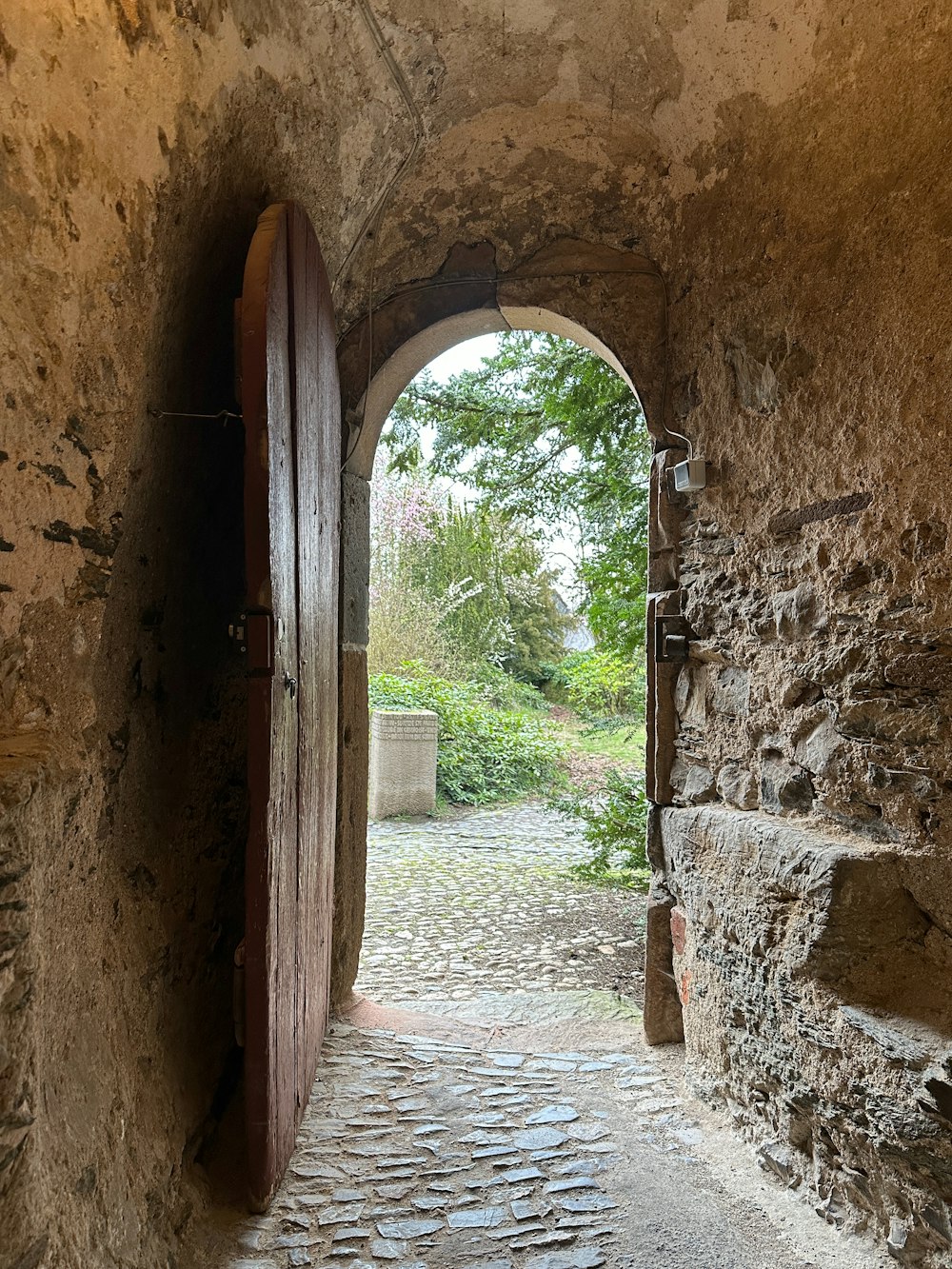 an open door leading to a stone path
