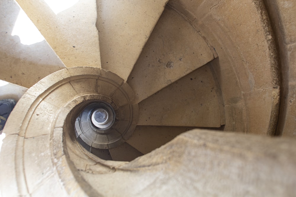 a spiral staircase in a building with a skylight