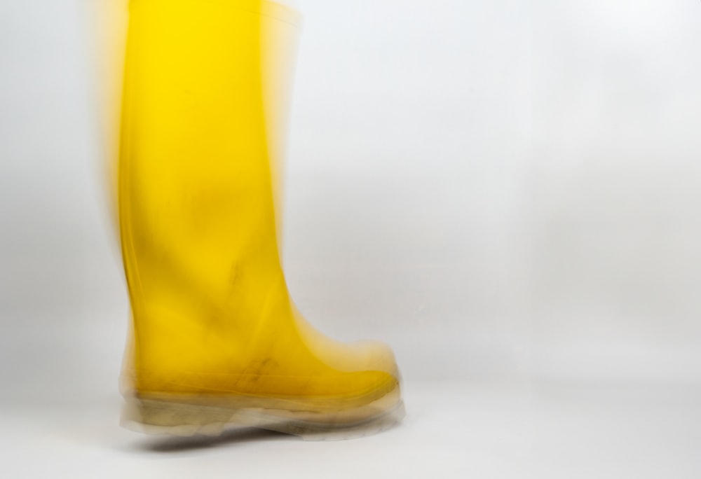 a woman's yellow boots with a white background