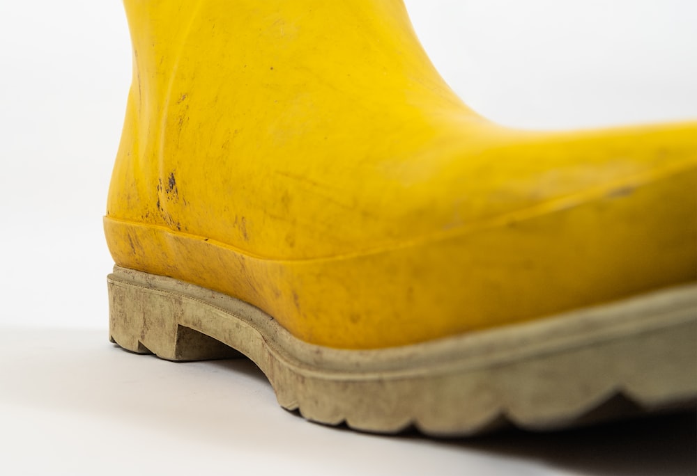 a close up of a yellow rubber boot