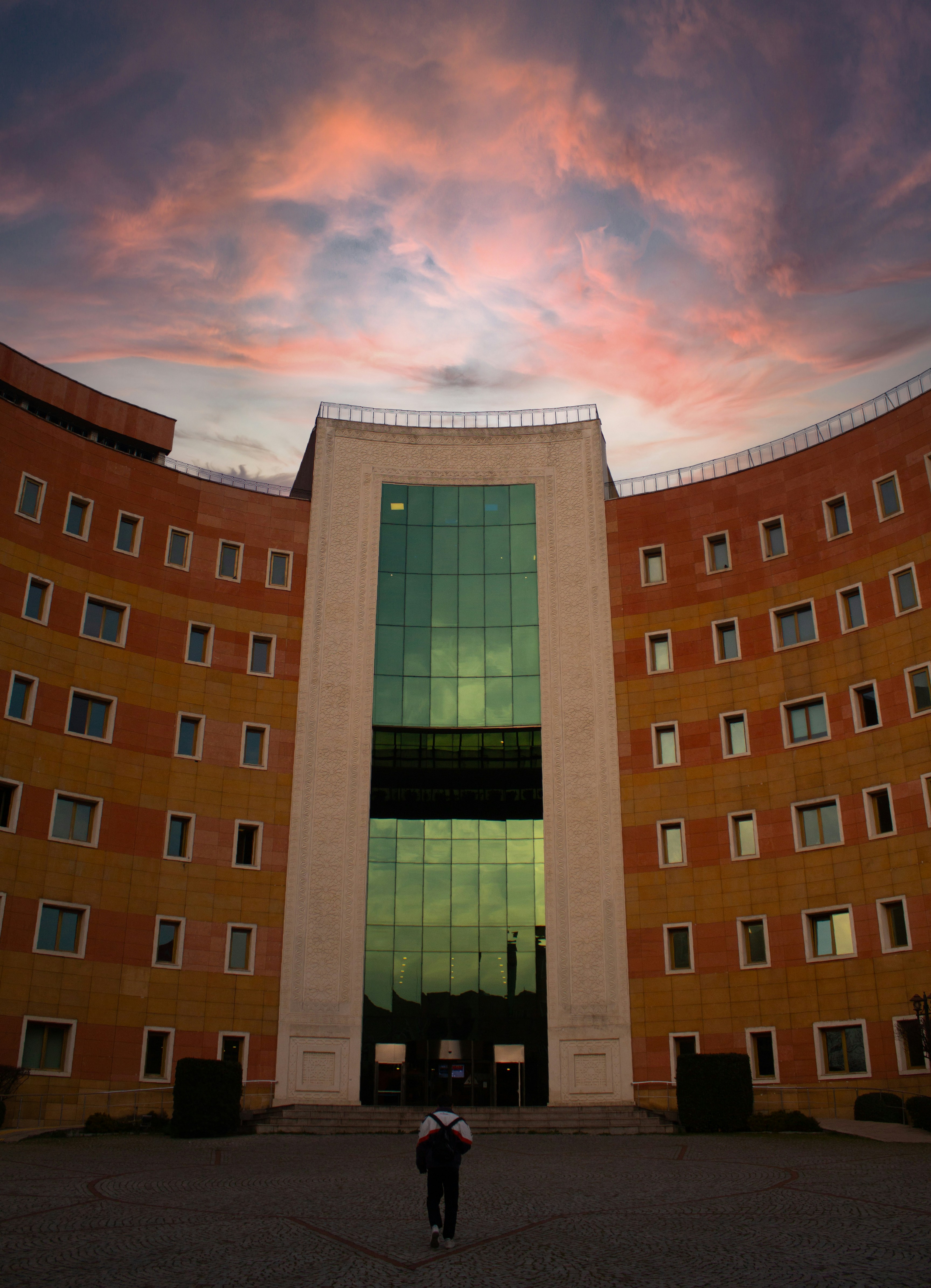 a person holding an umbrella in front of a building