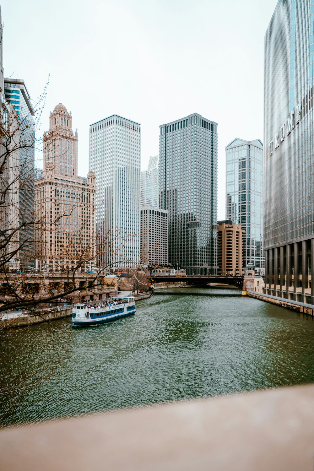 a boat traveling down a river next to tall buildings