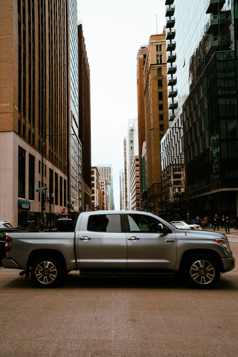 a silver truck parked on the side of the road