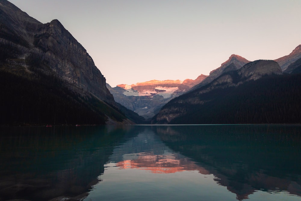 a body of water with mountains in the background