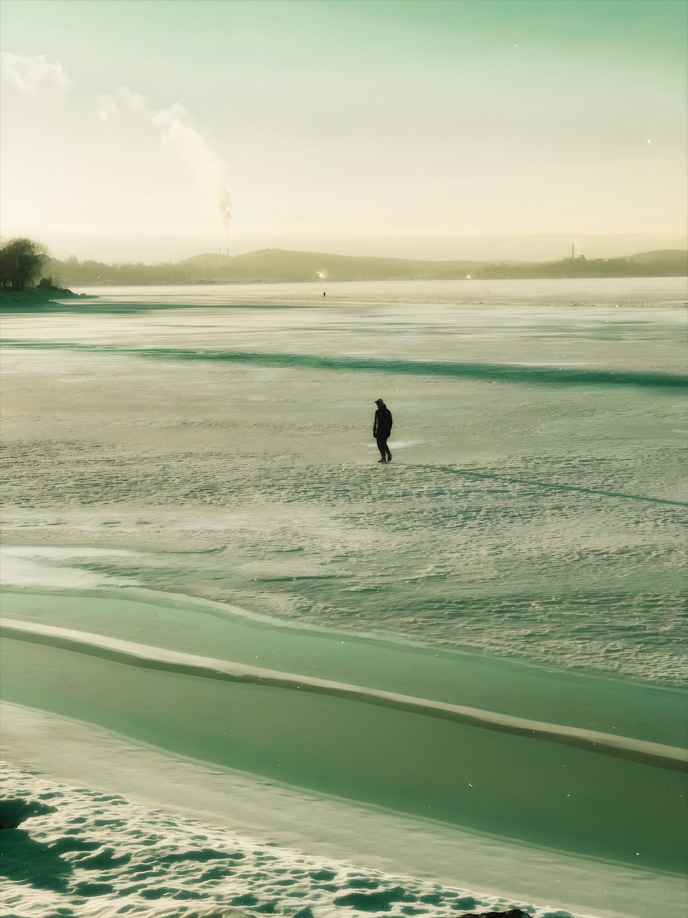 a person standing in the water at the beach