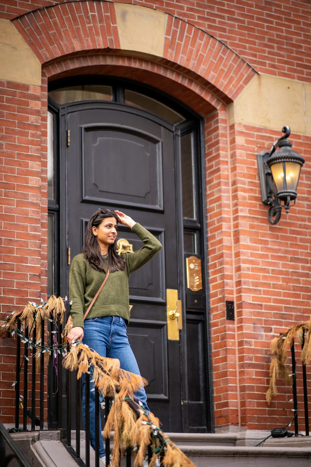 a woman standing on the steps of a building