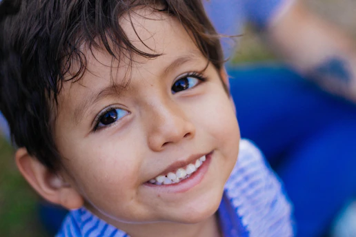 a close up of a child smiling at the camera