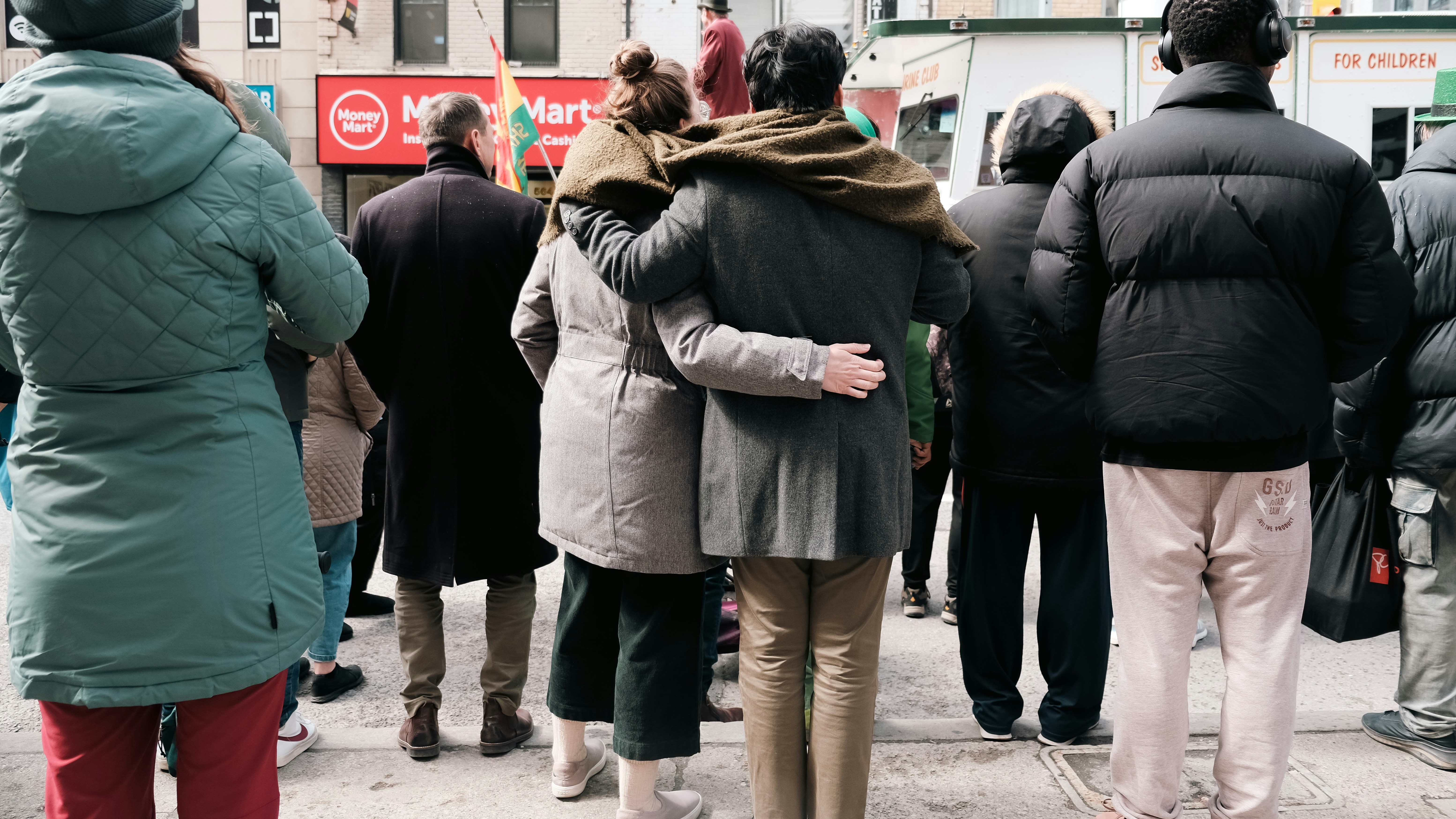 a group of people standing on a city street