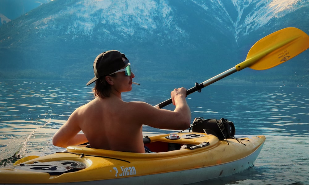 a man is paddling a kayak in the water