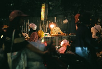 a group of people standing around a table