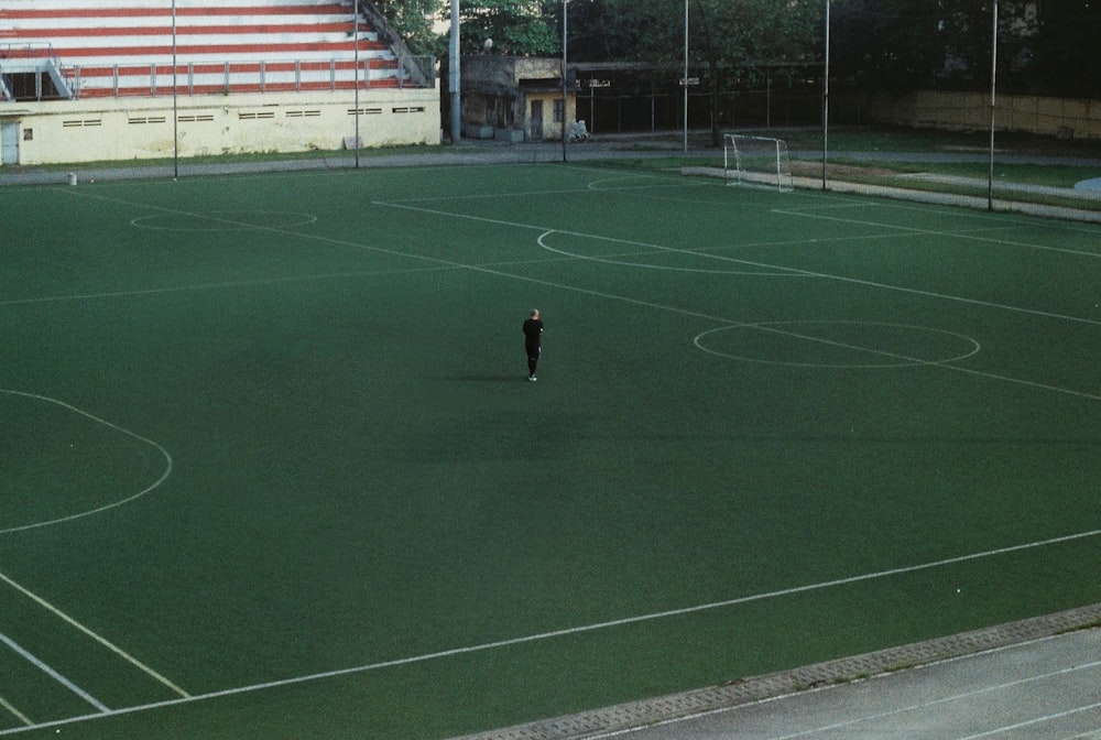 a person standing on a field with a soccer ball