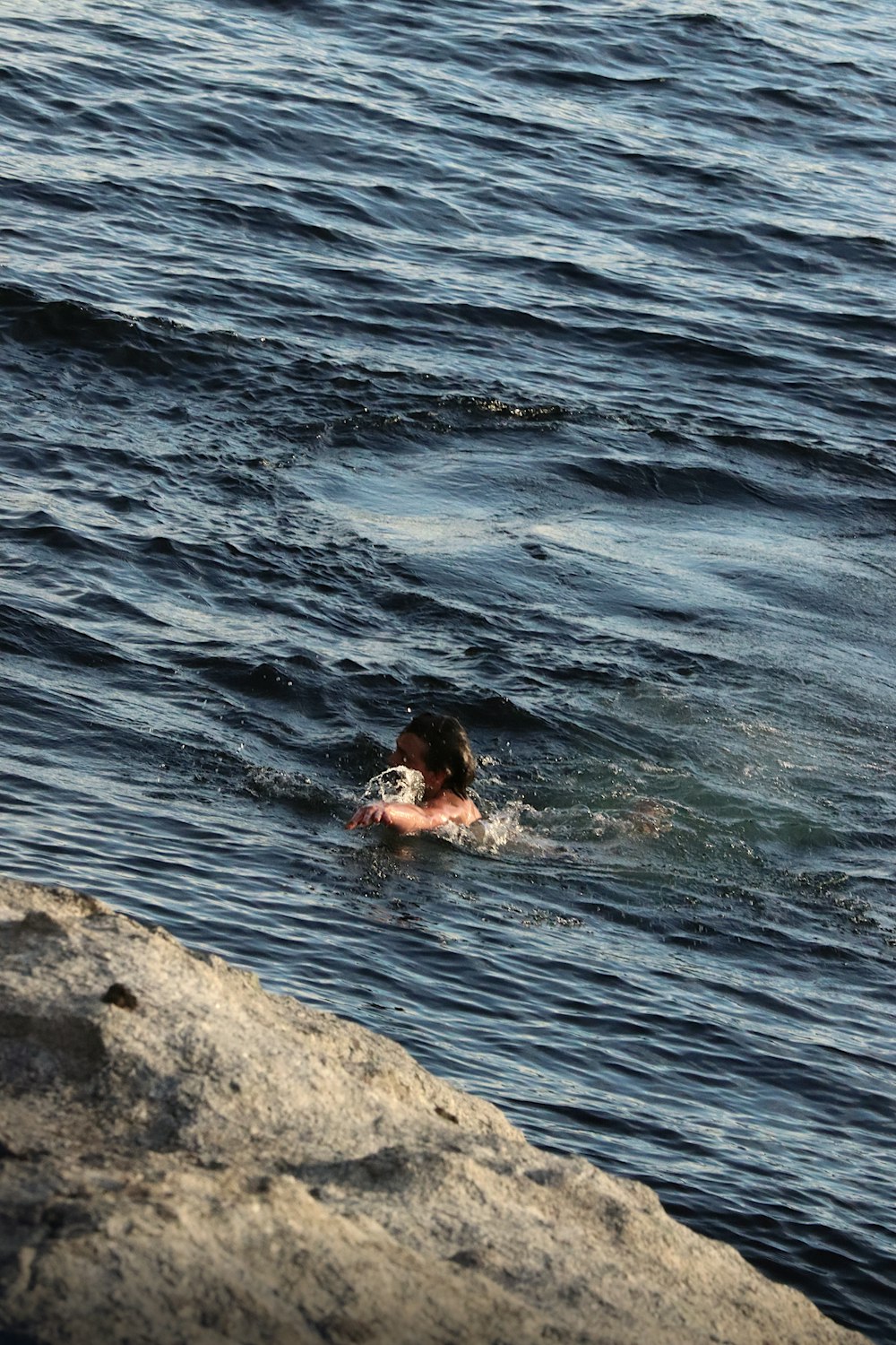 a person swimming in a body of water