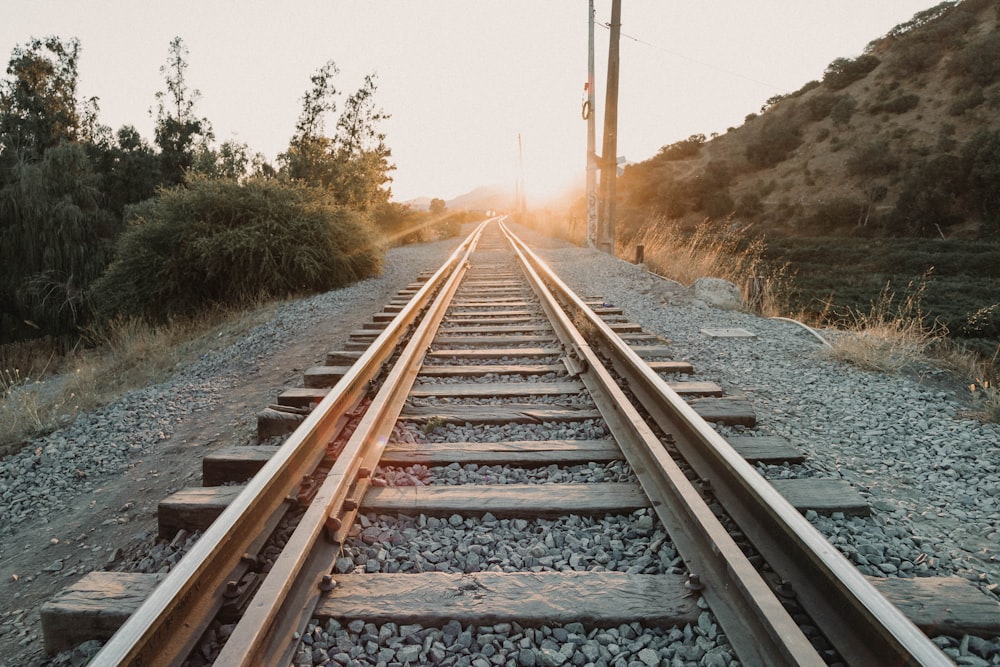 a train track with the sun going down