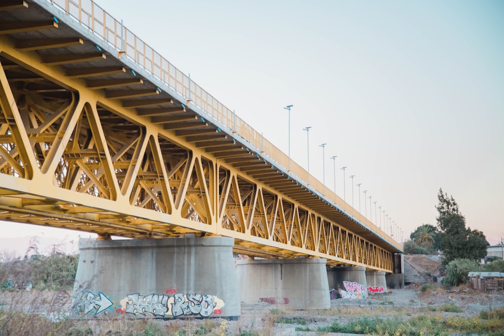 a bridge with graffiti on the side of it