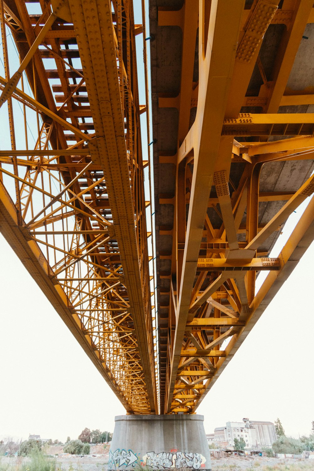 the underside of a bridge with graffiti on it