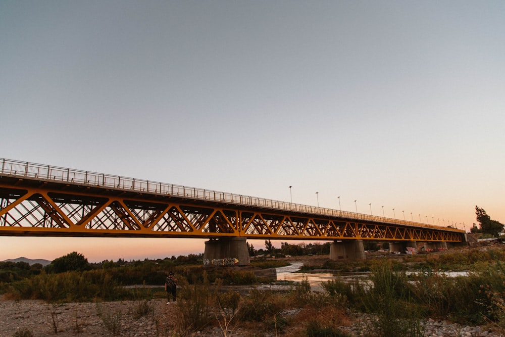 a bridge over a body of water at sunset