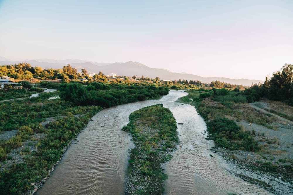 a river running through a lush green countryside