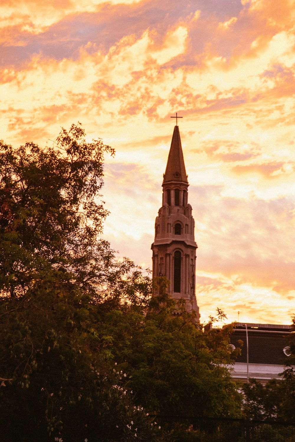 a church steeple with a sunset in the background