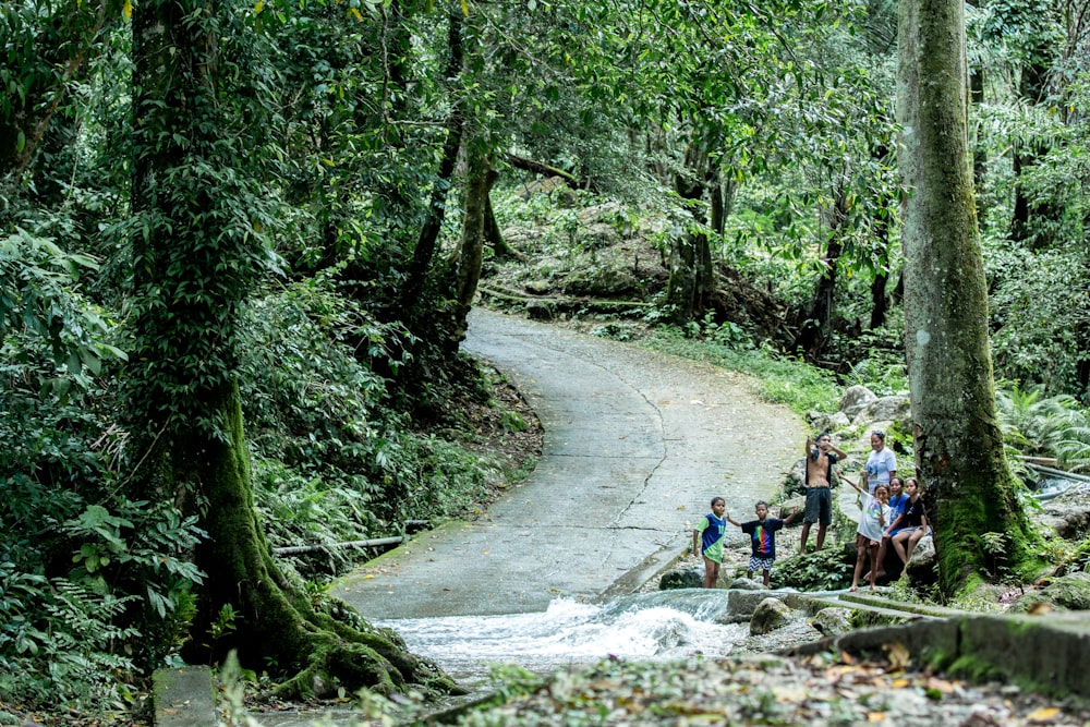 a group of people standing on the side of a road