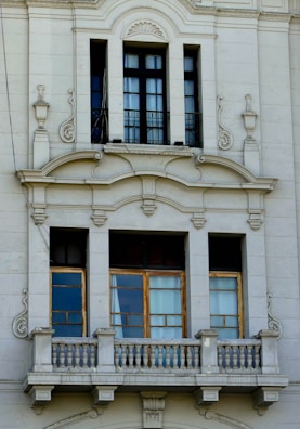 a white building with a clock on the front of it