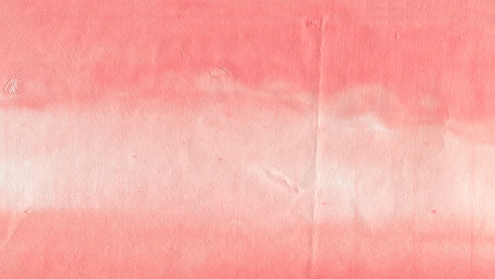 a piece of pink paper with a white background