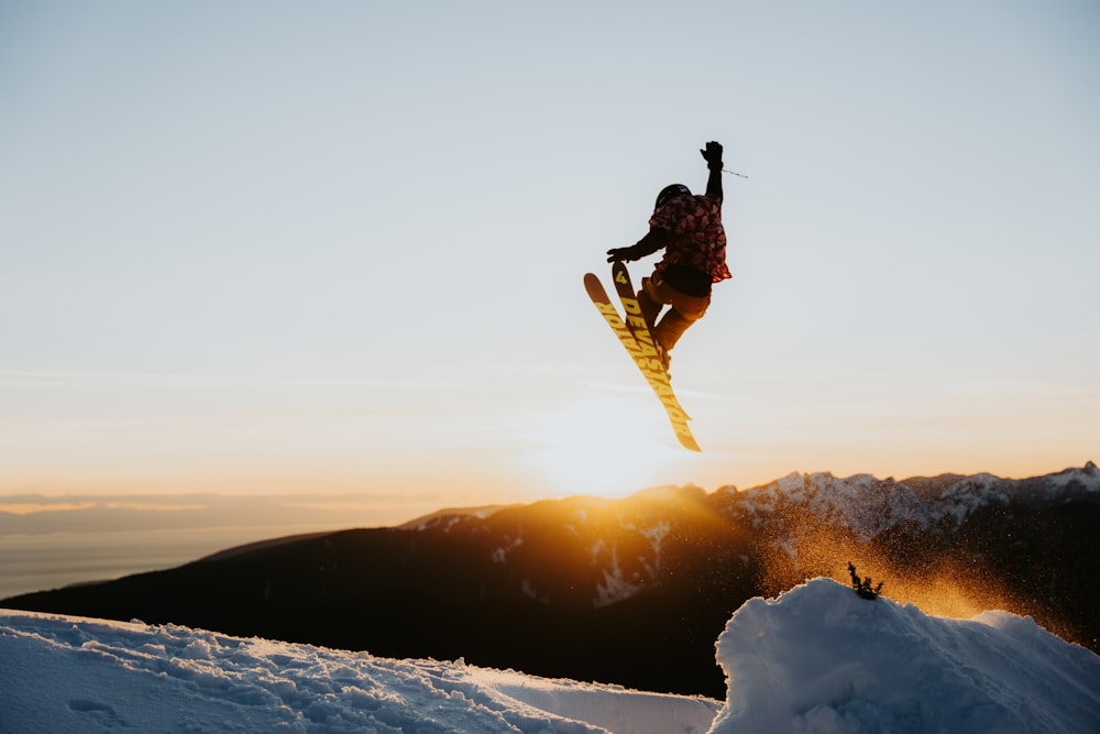 a person jumping a snow board in the air