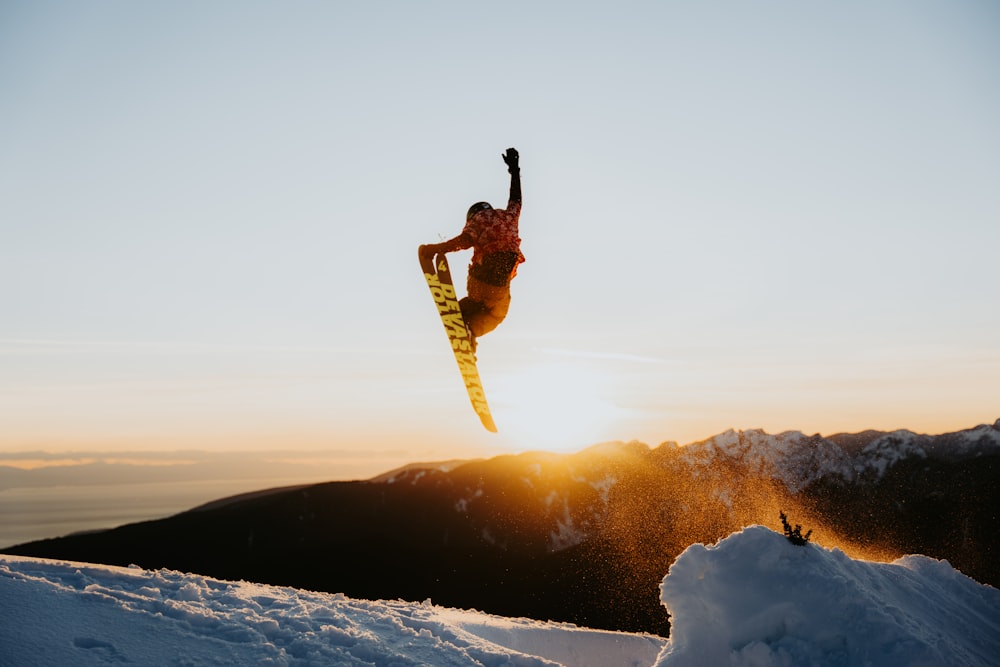 a person jumping a snow board in the air