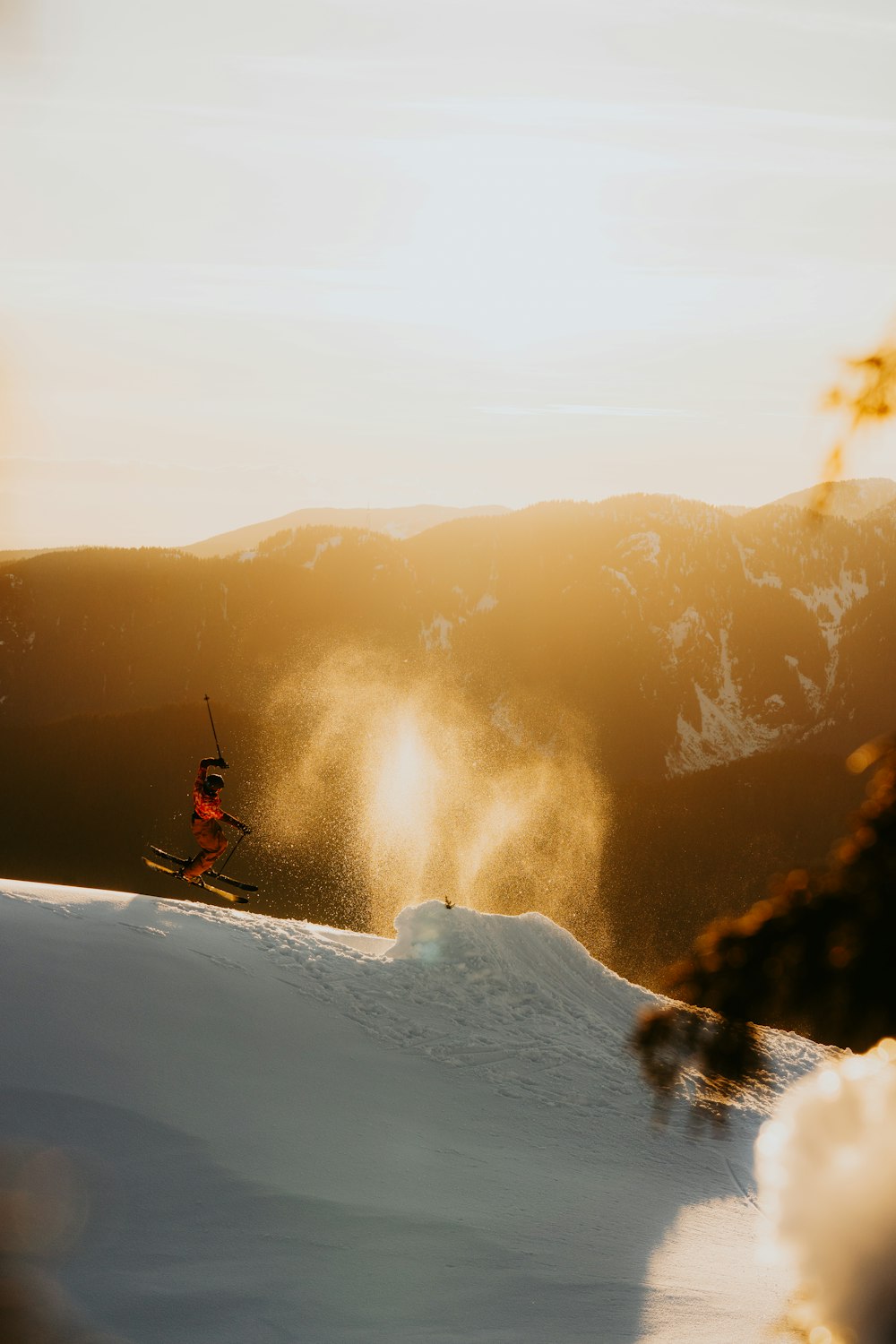 a person riding skis on top of a snow covered slope