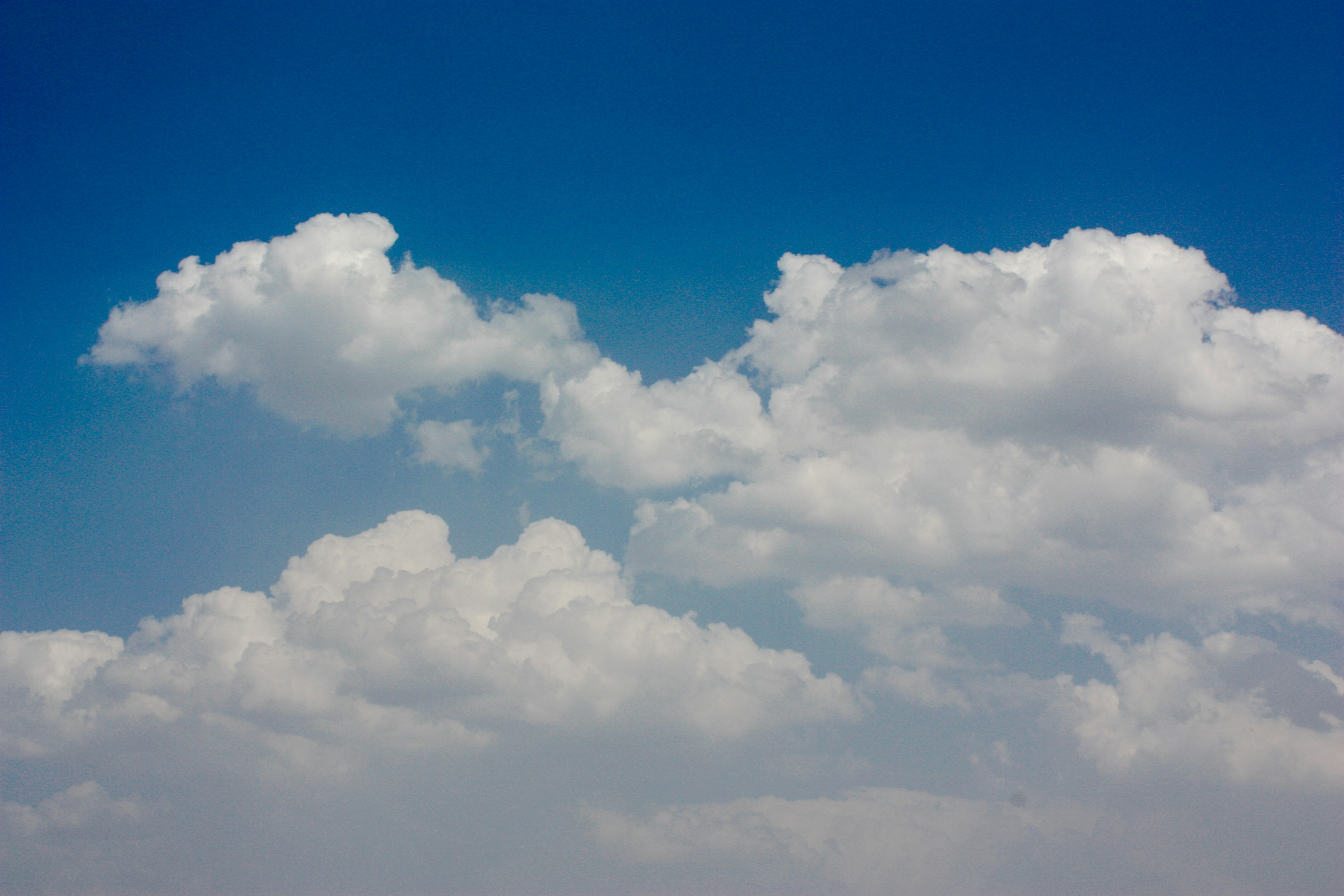 a plane flying in the sky with a lot of clouds