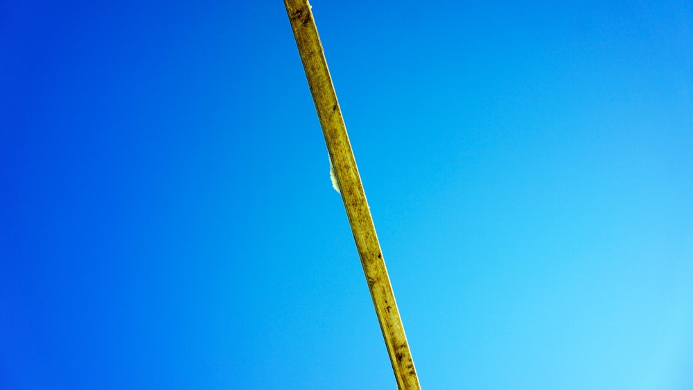 a street sign on a pole with a blue sky in the background