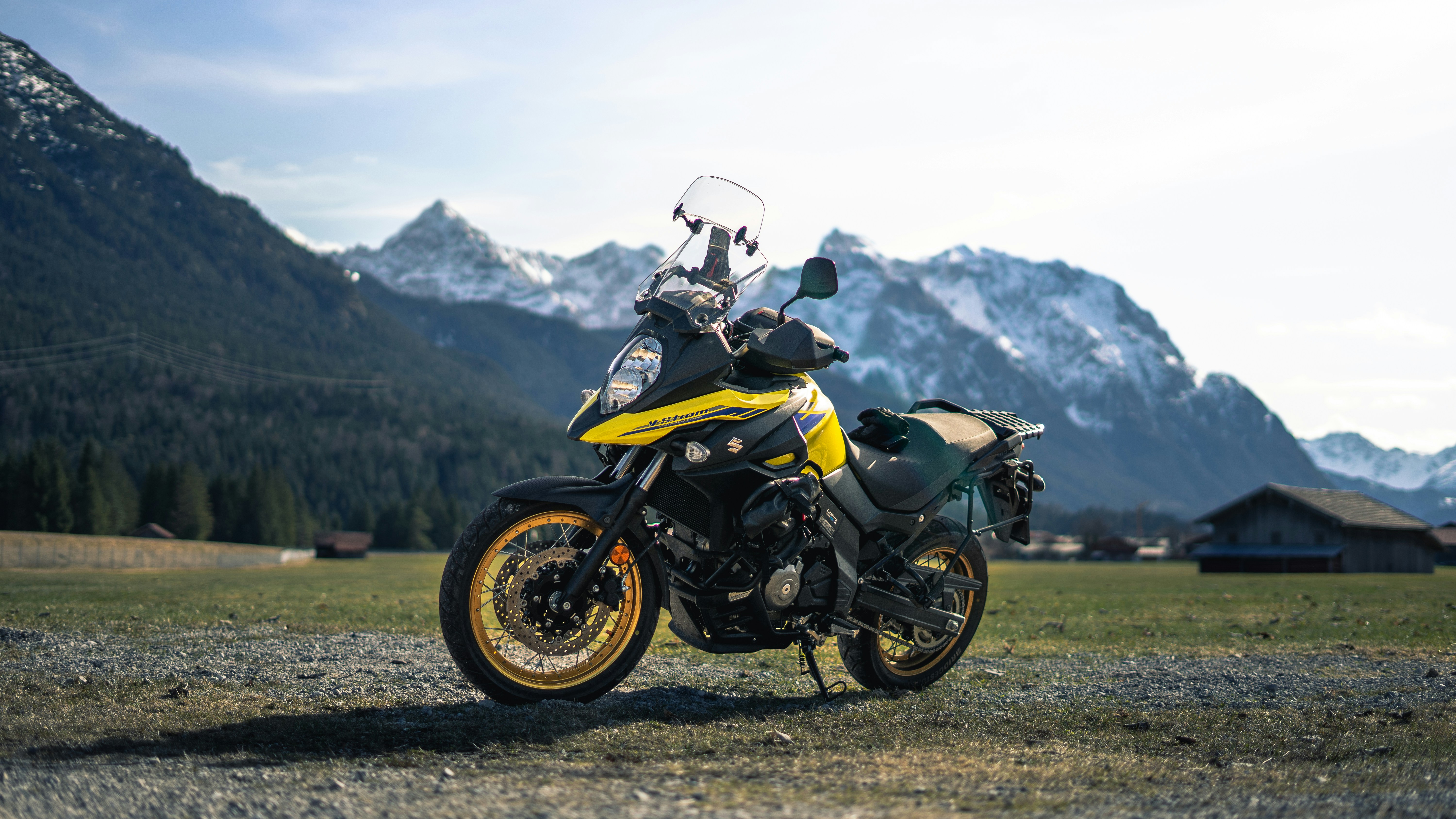 a yellow and black motorcycle parked in a field