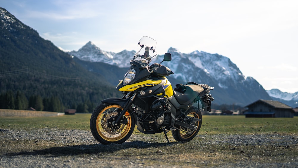 a yellow and black motorcycle parked in a field