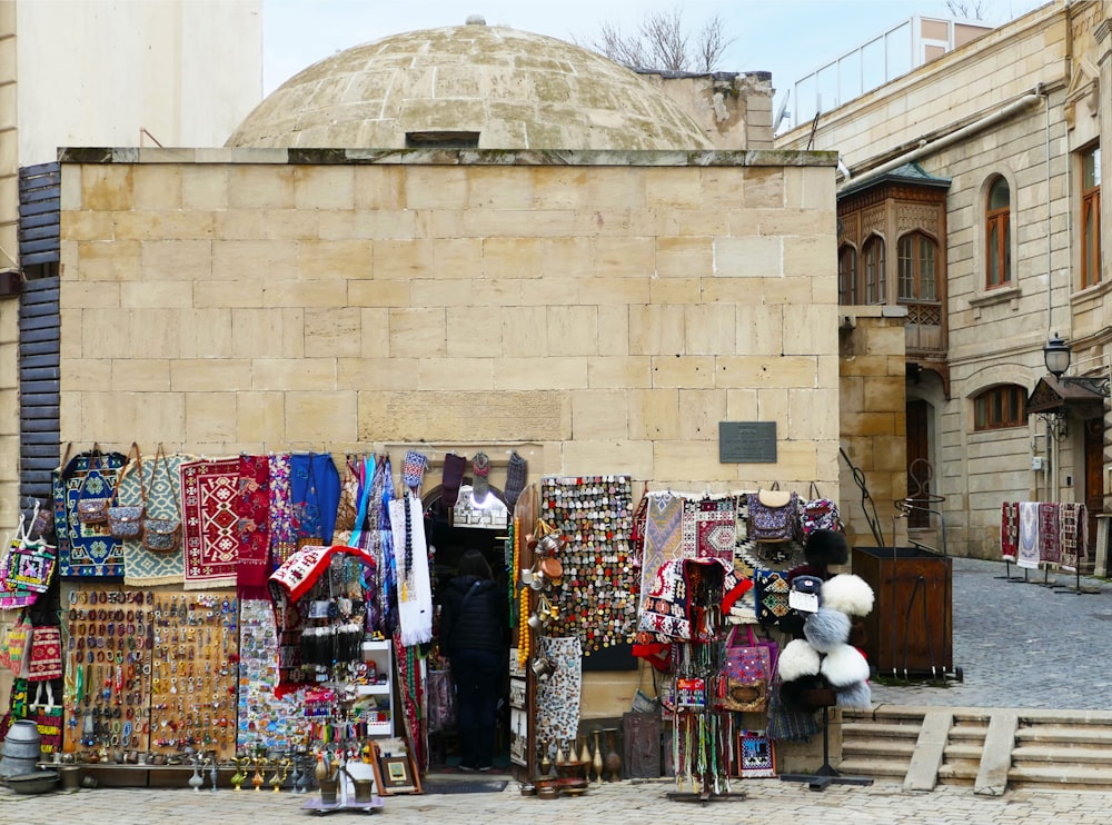 a man standing in front of a store selling items