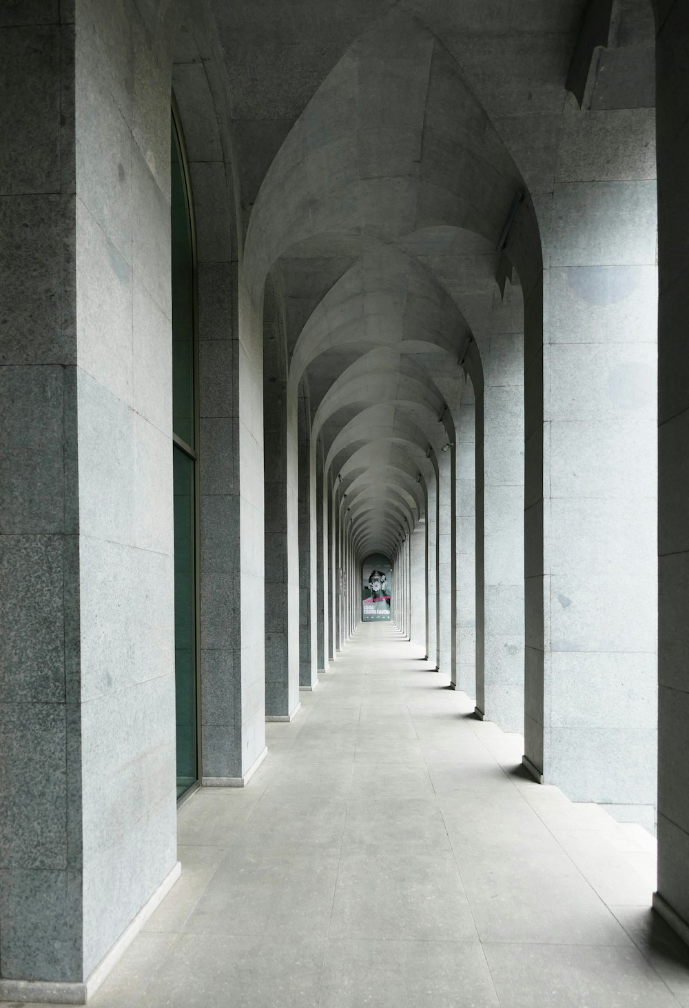 a long hallway with a clock on the side of it