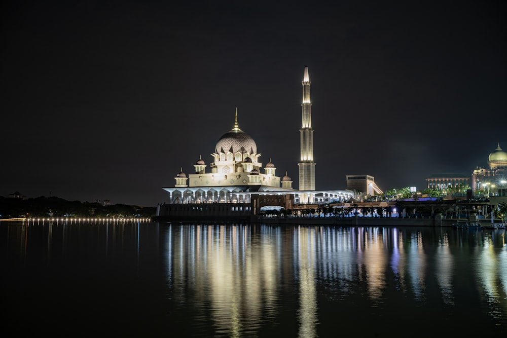 a night view of a large white building