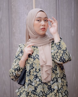a woman in a hijab holding an umbrella
