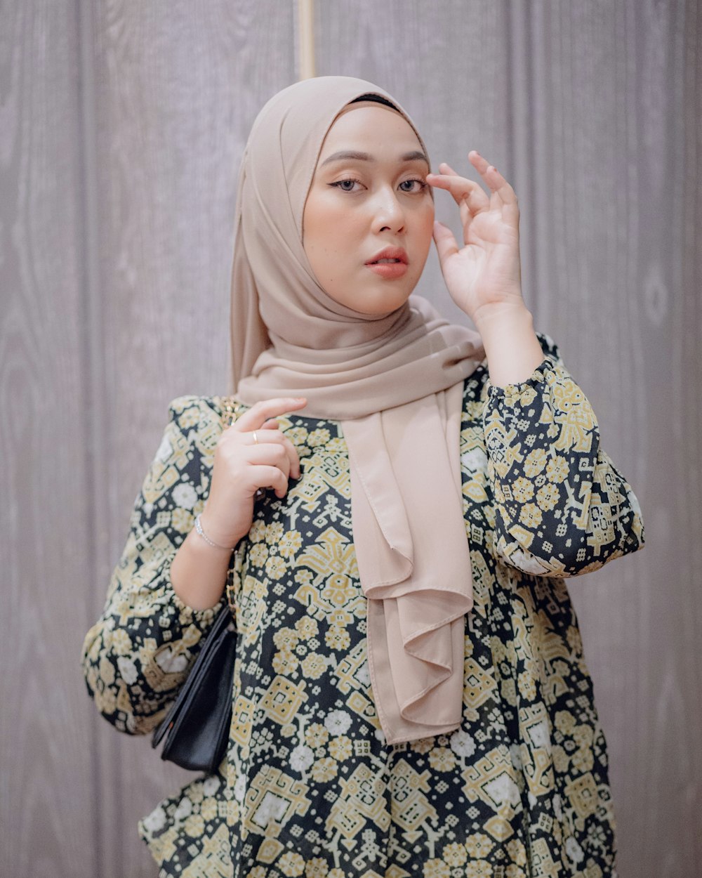 a woman in a hijab holding an umbrella