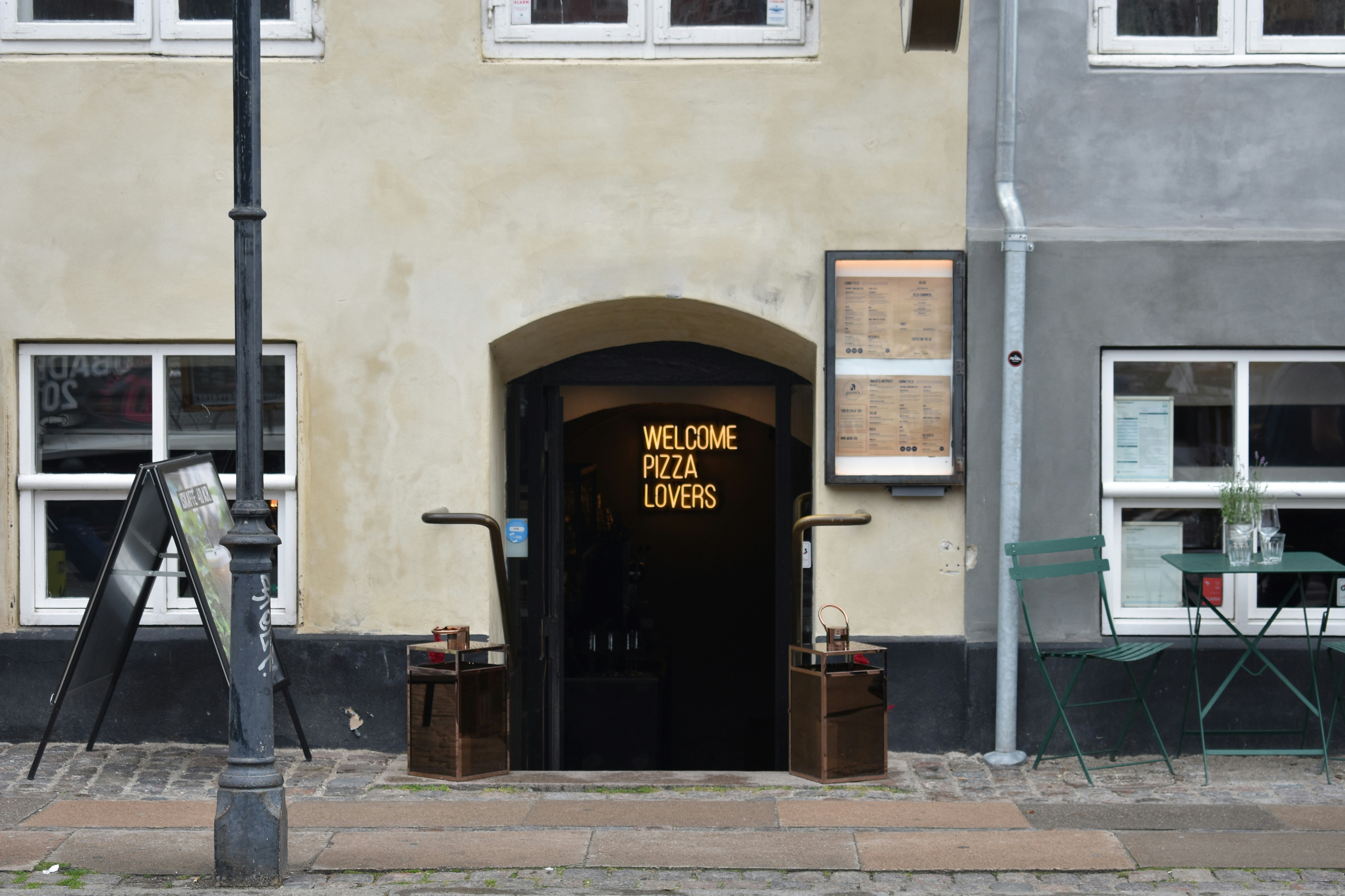 building with welcome pizza lovers sign