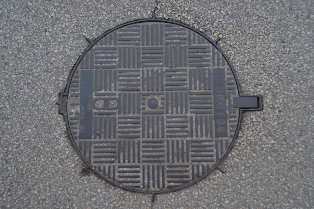 a manhole cover on the ground in the middle of the street