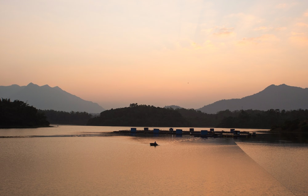 a body of water with mountains in the background