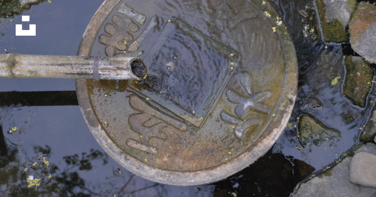 Metal Puddle A metal object sitting on top of a puddle of water photo – Free Grey ...