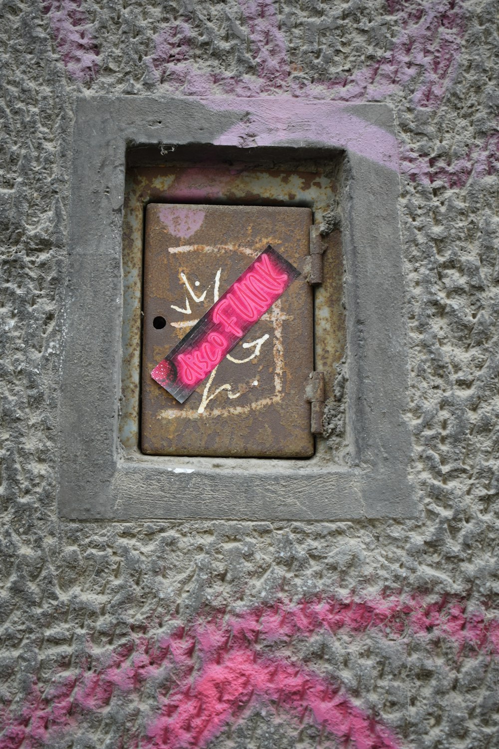 a square hole with a pink object in it