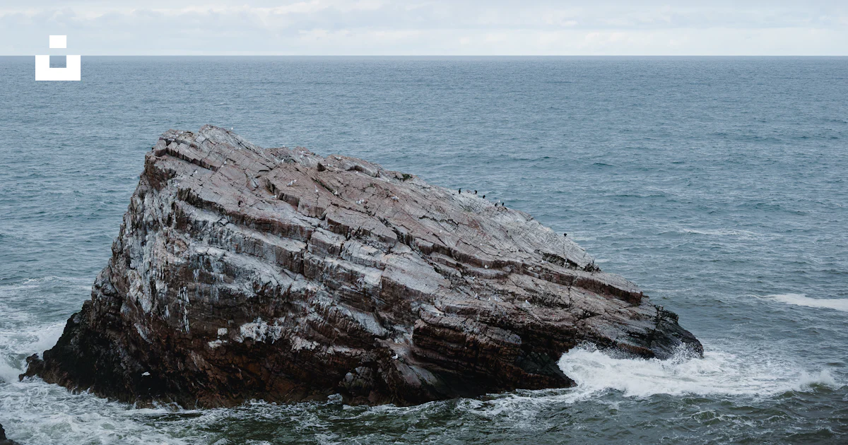 A large rock sticking out of the ocean photo – Free Bow fiddle rock ...