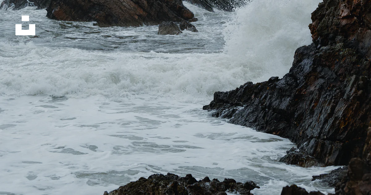 A large rock sticking out of the ocean photo – Free Nature Image on ...