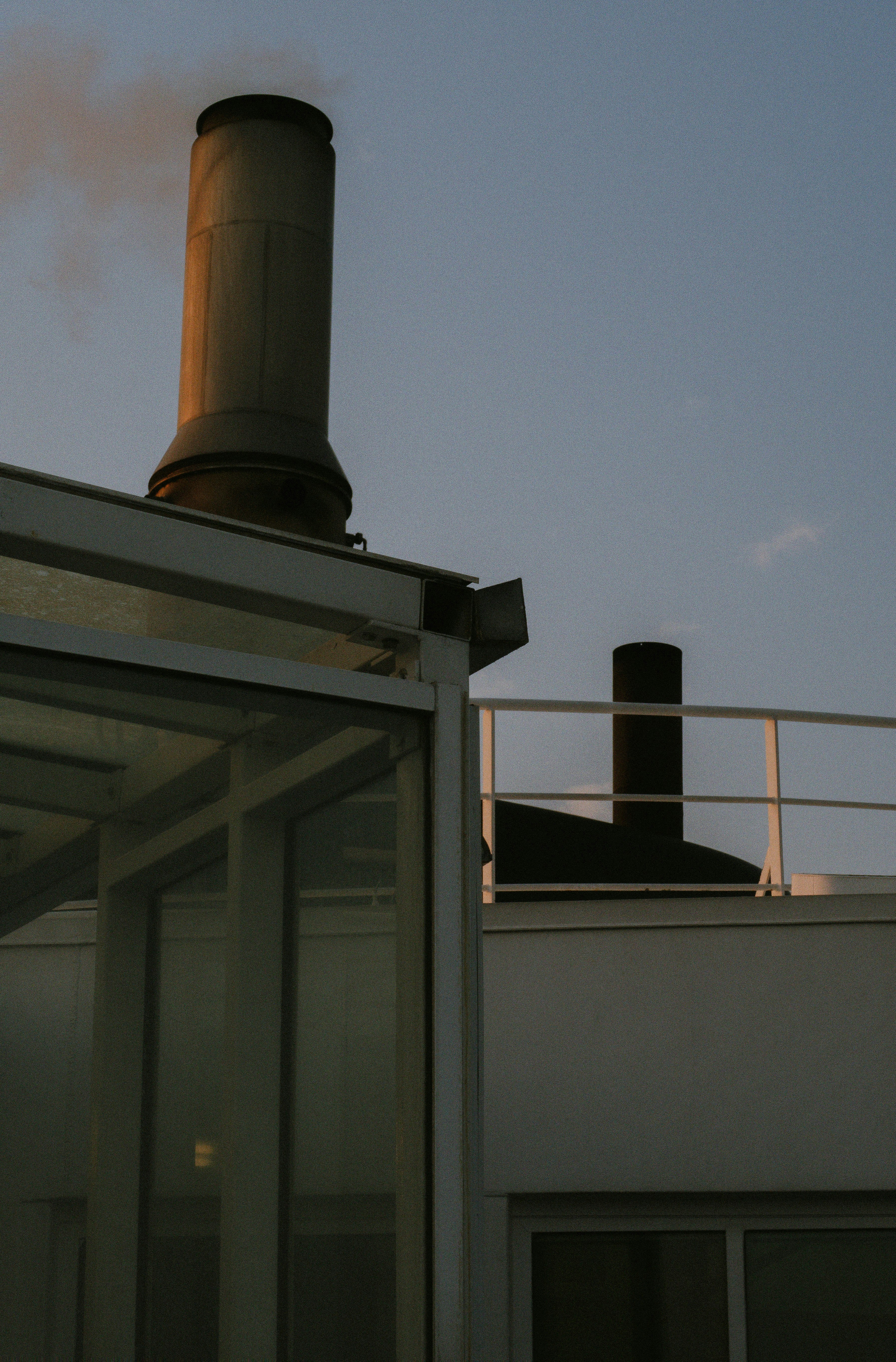 smoke coming out of a chimney on top of a building