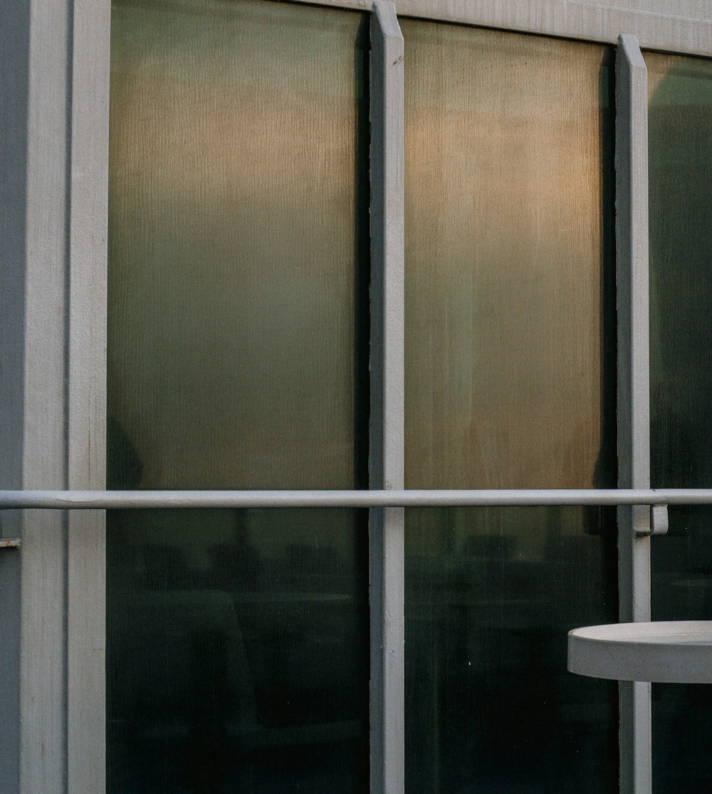 a cat sitting on a window sill outside of a building