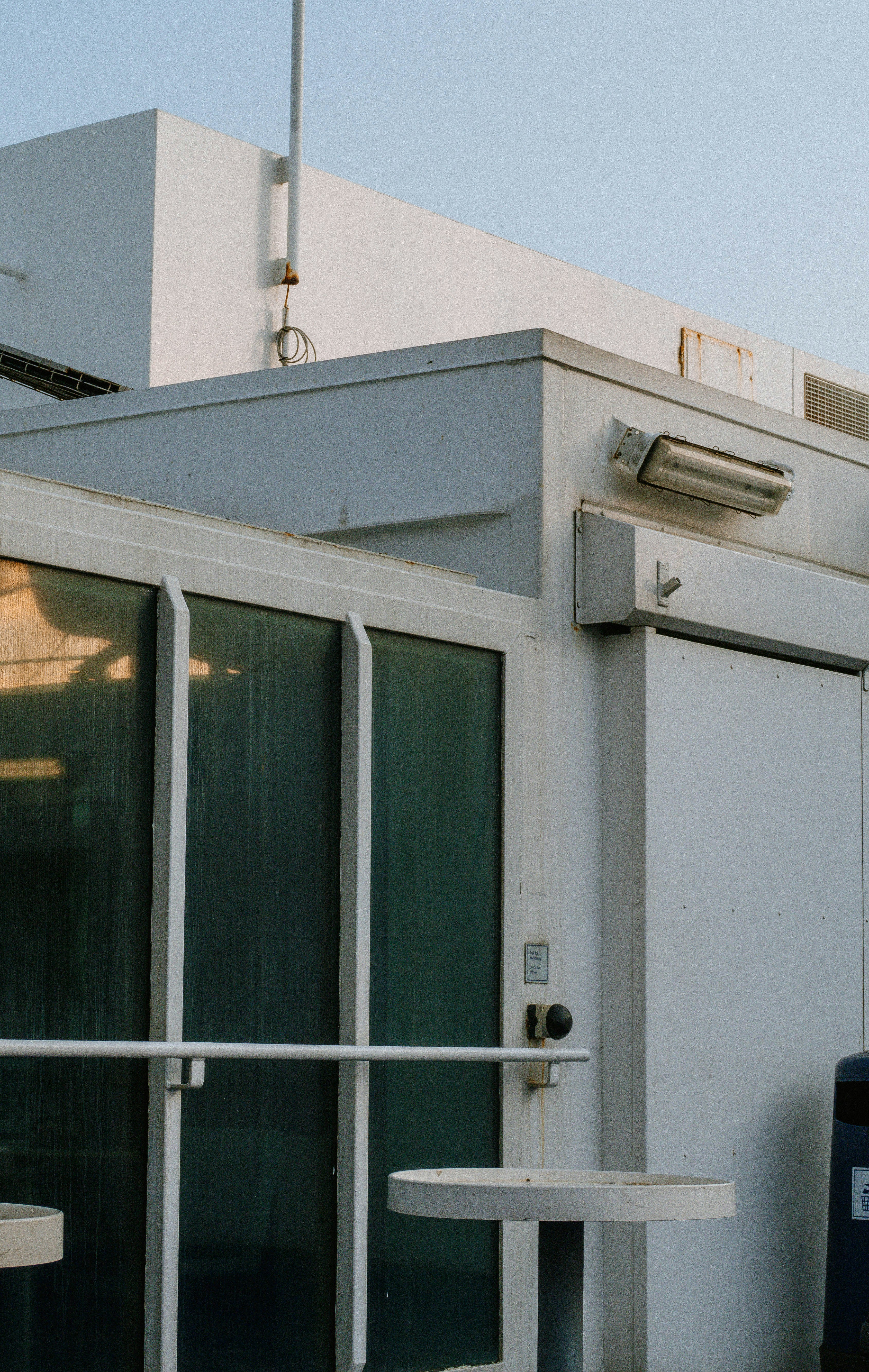 a white building with a metal fence around it